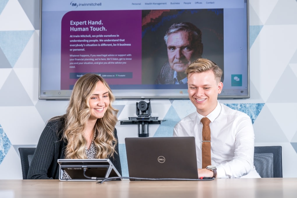 Two work placement students working together at a laptop